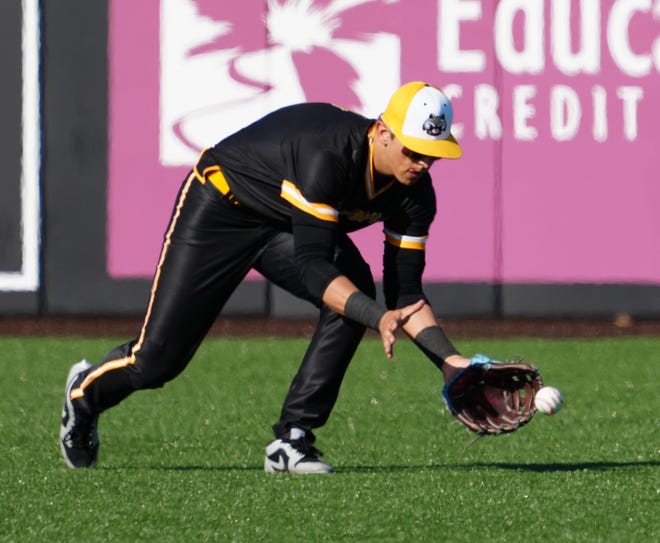 Oconomowoc right fielder Bradyn Nelson (6) scoops up a ground ball during the game against Pewaukee at Dockhounds Stadium in Oconomowoc, Wednesday, April 24, 2024.